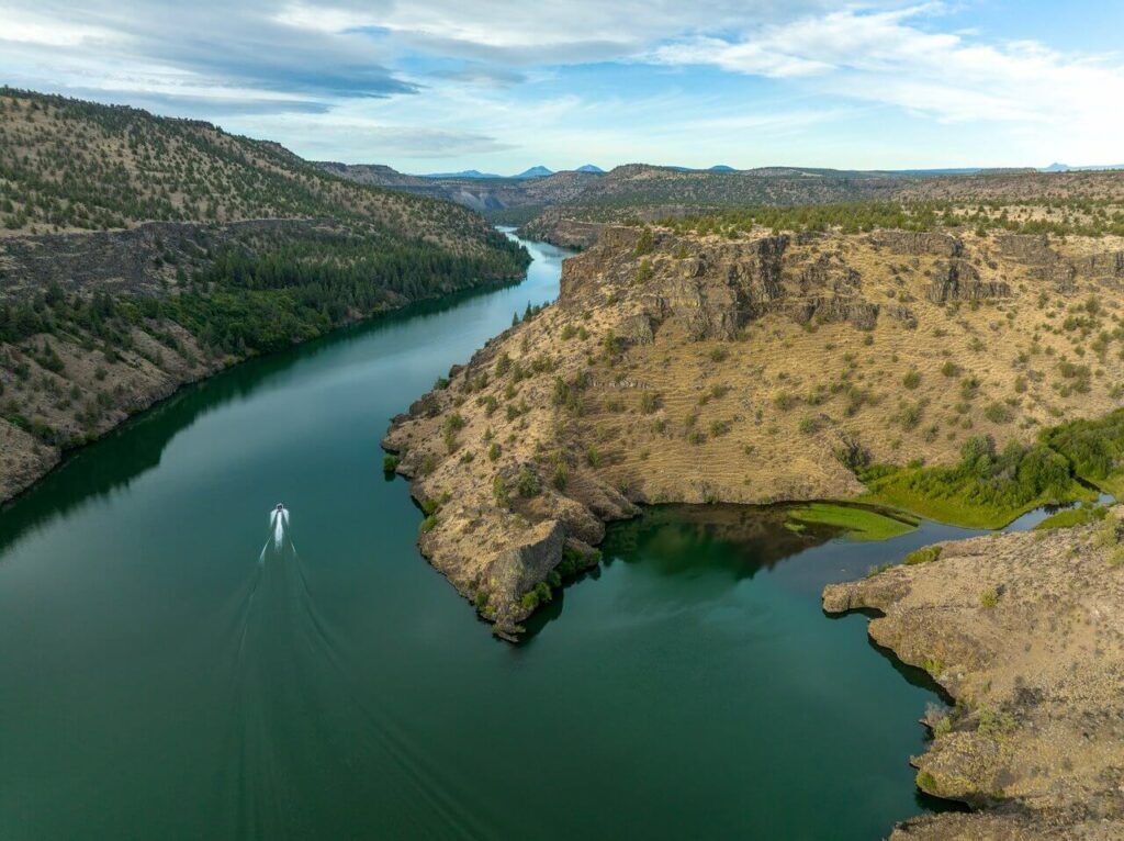 Boaters enjoying the pristine waters of Lake Billy Chinook, encapsulating the essence of waterborne adventure.